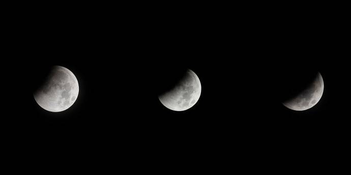 The moon shown in three phases against a black sky